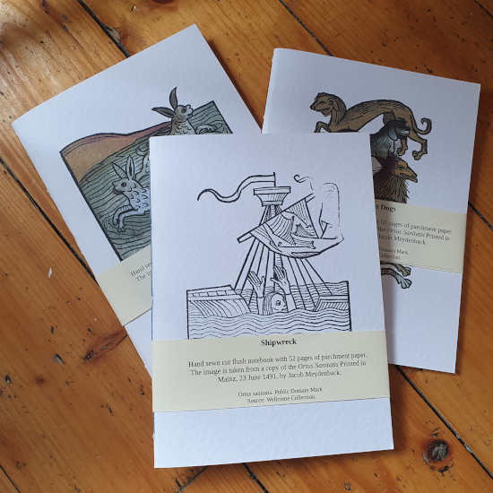 a  page notebook with a woodcut or inked image from or inspired by history 