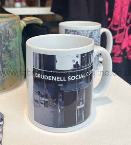 a mug with a black and white photograph of a leeds pub