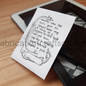 A bookplate sticker with text and two dragons on leaned up against some digital tablets.