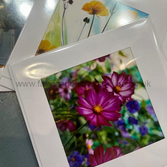 a miniature glass dome on a cork base containing a dried flower arrangement