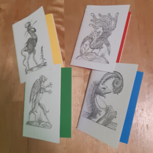 Four pamphlet notebooks with white covers. Each has an historic woodblock image of a monster on the front and differently coloured endpages.