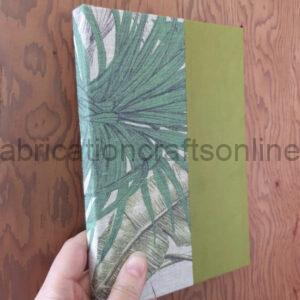 An A5ish hardback notebook with patterned fabric on the spine and paper in a complimentary colour on the covers.