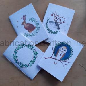 Four white pamphlets with watercolour images of winter animals.