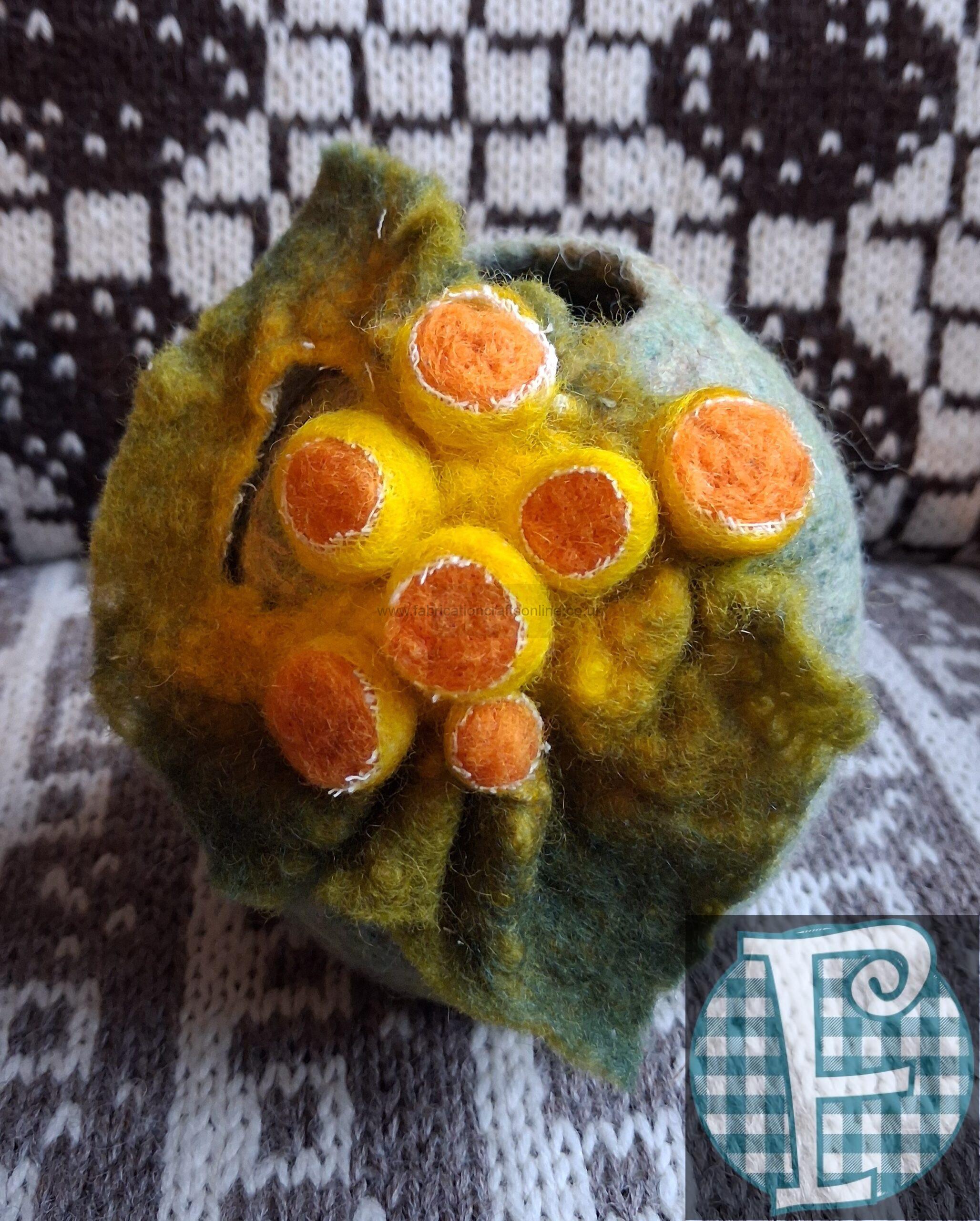 felted lichen vase which can be used for displaying dried flowers 