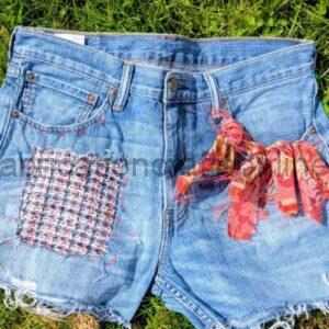 resued levi jeans re purposed into hotpants  then rag rugging detail with reclaimed fabrics is added along with sashiko style visible mending 