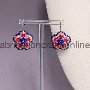 Beaded flower-shaped earrings on a metal stand, featuring blue centers and pink petals with dark blue edges.