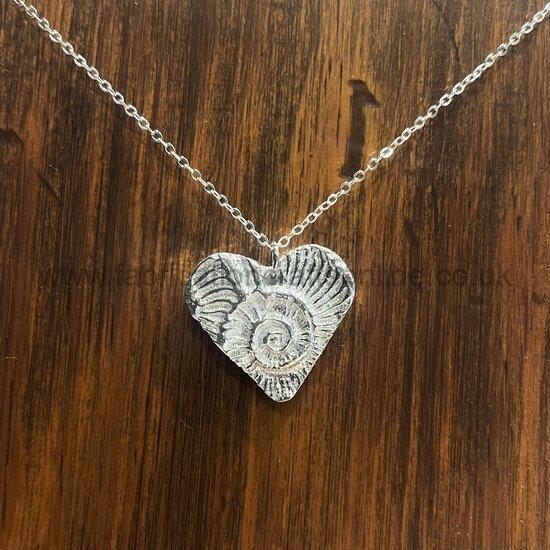 pewter heart pendant one off a and a pamphlets using decorative card finished with a vintage inspired label interior pages are blank
nb photo is not representative of current stock online sales will have a notebook chosen at random