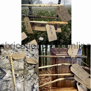 Rustic wooden rails with handwritten tags tied on strings in a meadow; a memory/wishing tree display.