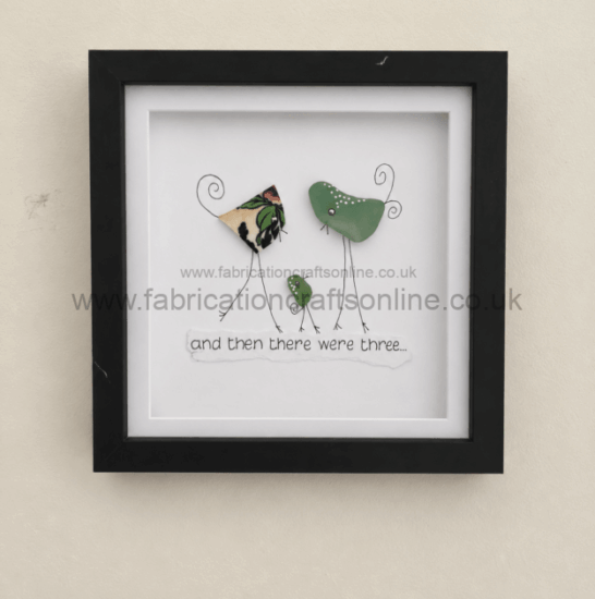 Framed mixed-media artwork of three bird figures made from metal shapes and wire, with the caption 'and then there were three...'