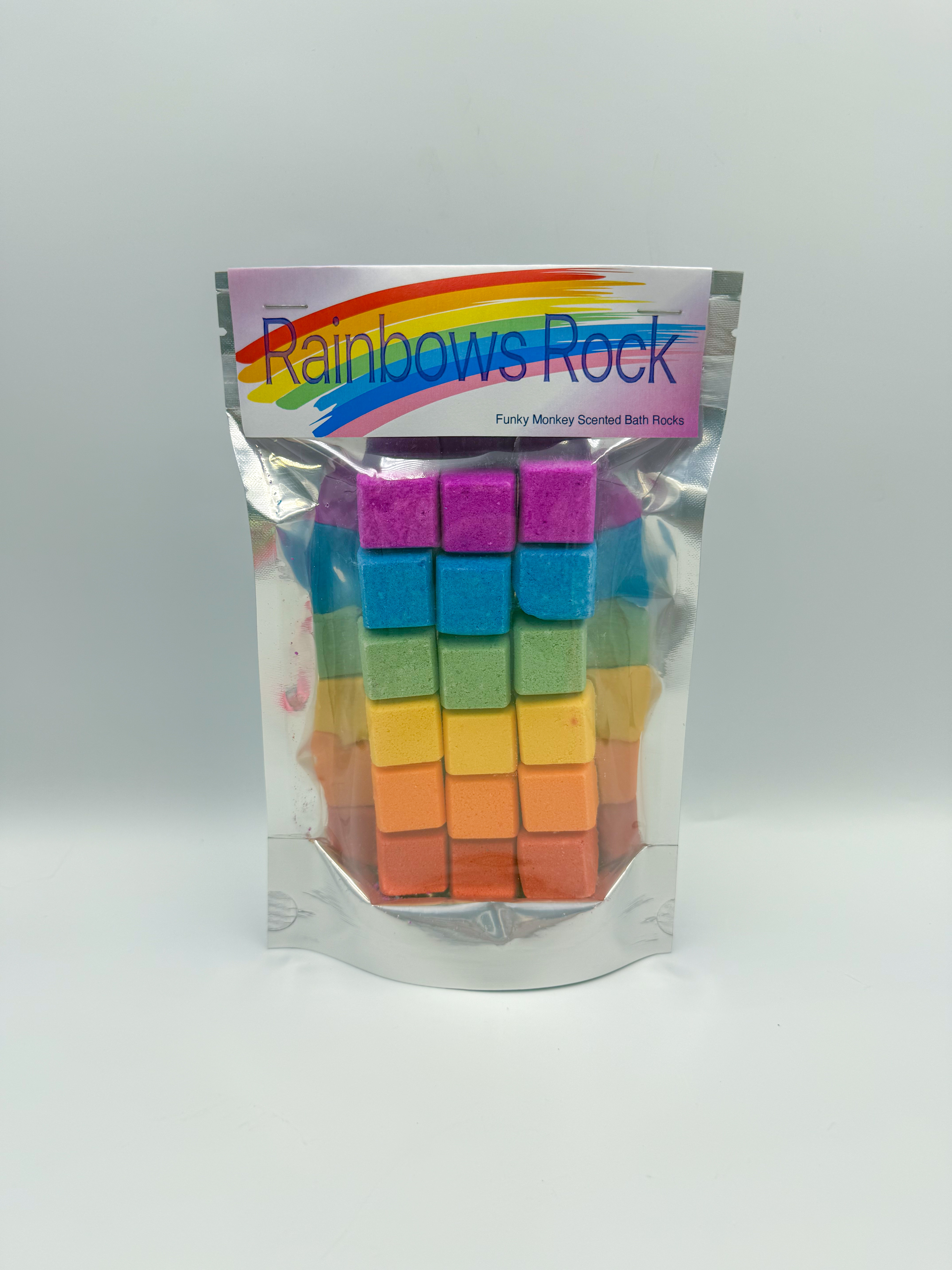 Bag of Rainbow's Rock Funky Monkey scented bath rocks; rainbow-colored square cubes visible inside the pouch.