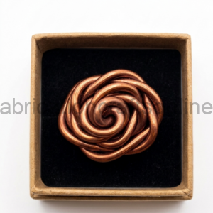 Copper-toned metal knot jewelry piece arranged in a circular spiral inside a black tray within a brown gift box.