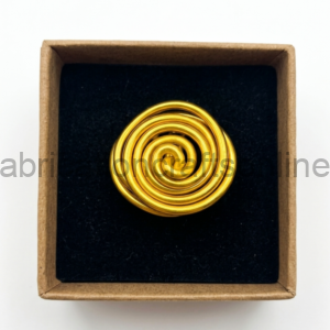 Gold spiral jewelry piece (brooch/pin) resting on black foam inside a small brown gift box.