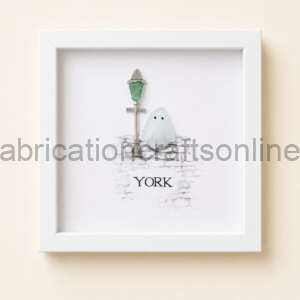 Framed illustration of a ghost beside a vintage lamppost on a cobblestone wall with the word YORK beneath it