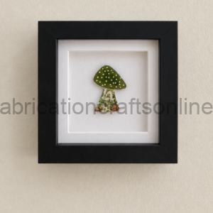 Framed artwork of a small green mushroom with a dotted cap and a floral-patterned stem, mounted on a white mat.