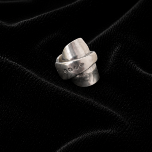 Silver stacked ring with two bands resting on black velvet.