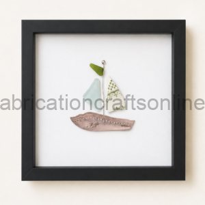 Framed wall art with ceramic pieces arranged as a sailboat on a white background.
