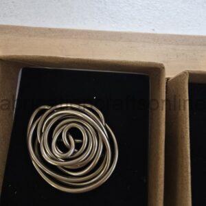 Open jewelry box showing circular silver bangles arranged in a black inner tray in velvet-lined compartment.