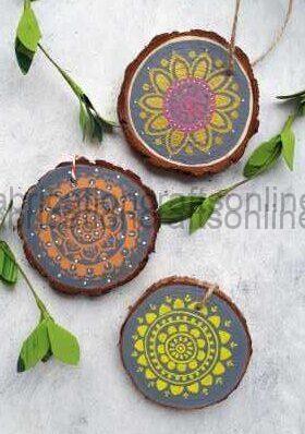 Three round wooden coasters painted with intricate mandala designs on a light background.