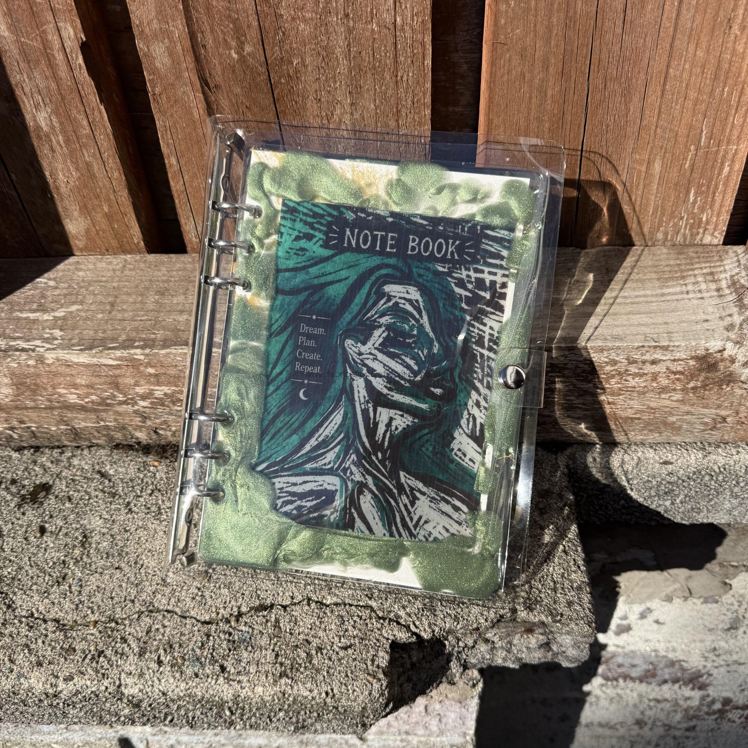 img  handmade a refillable notebook with an original alova artwork set within a hand poured resin cover warm copper and gold tones with subtle blue details make each piece unique