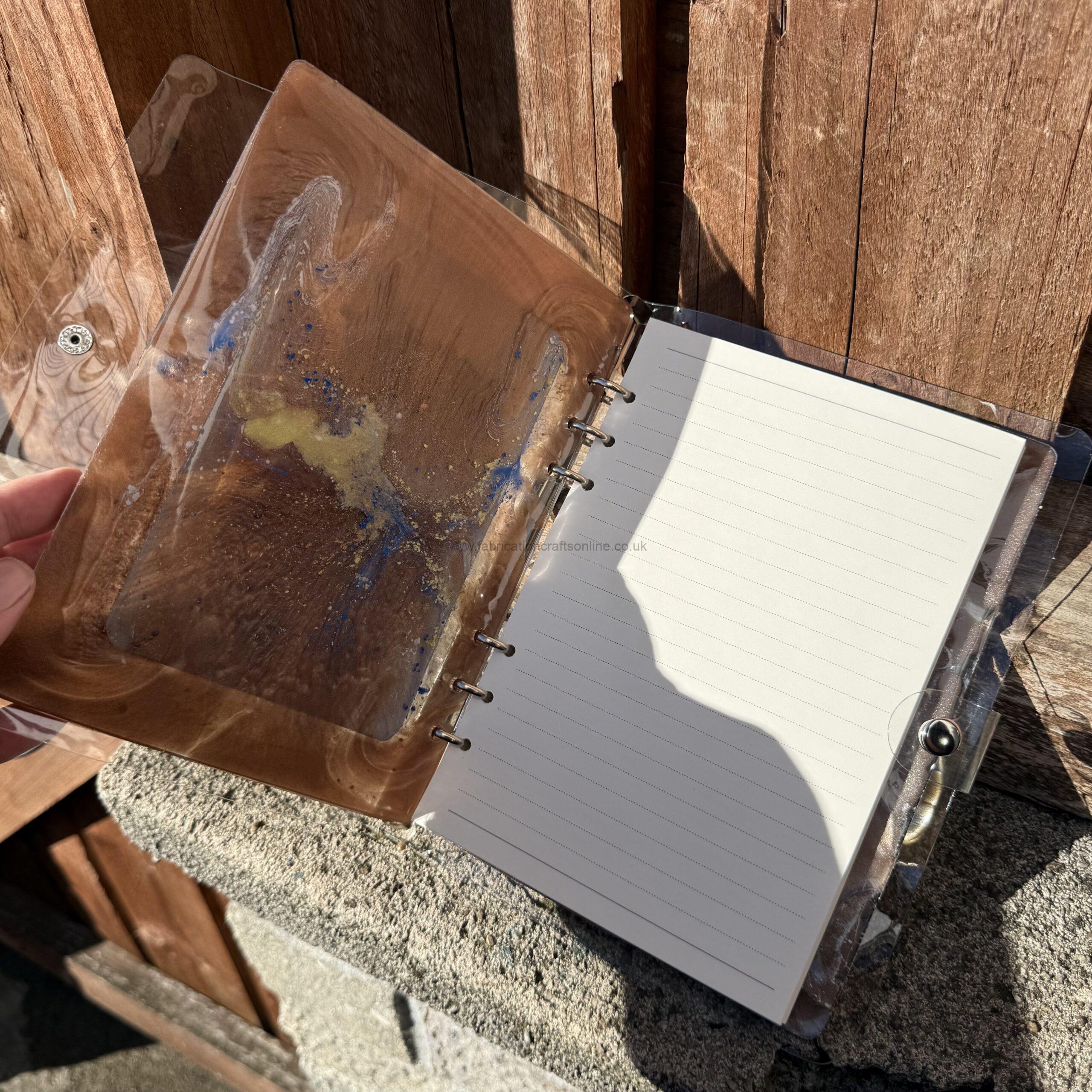 img handmade a refillable notebook with an original alova artwork set within a hand poured resin cover warm copper and gold tones with subtle blue details make each piece unique