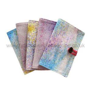 Five colorful, paint-splattered canvases fanned in order, with a red paint roller resting on the right edge.