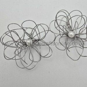 Two abstract wire flowers with tangled silver loops and a central pearl bead.