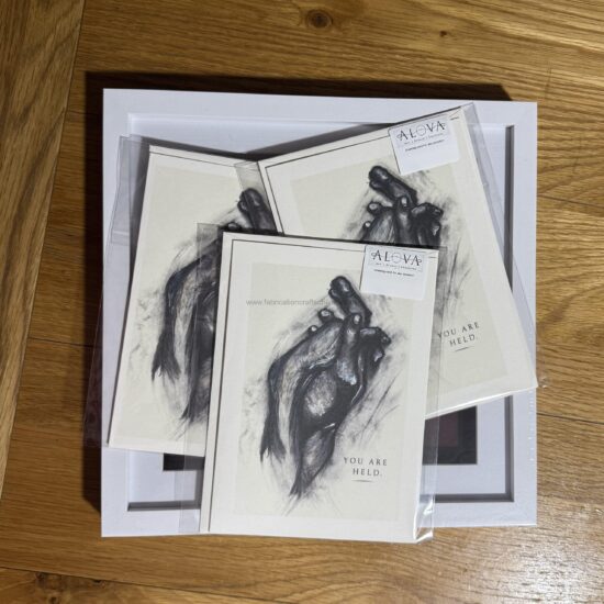 you are held art greeting card a meaningful × cm art greeting card featuring an expressive illustration of intertwined hands and the words you are held a gentle reminder of connection comfort and support